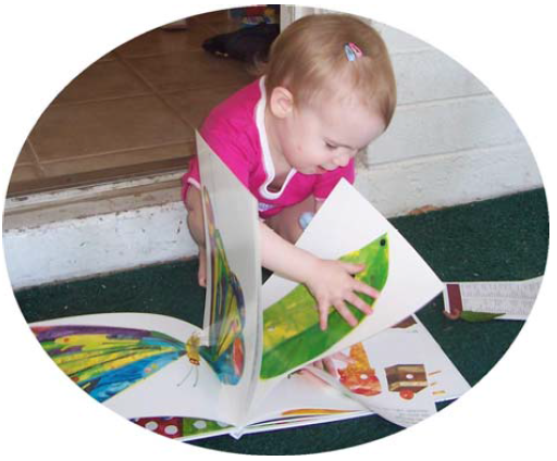 A toddler explores a tactile book.