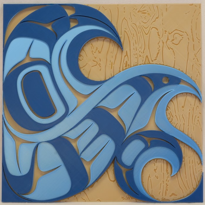 A tactile wave art piece with various shapes and cutouts in it on a wooden background