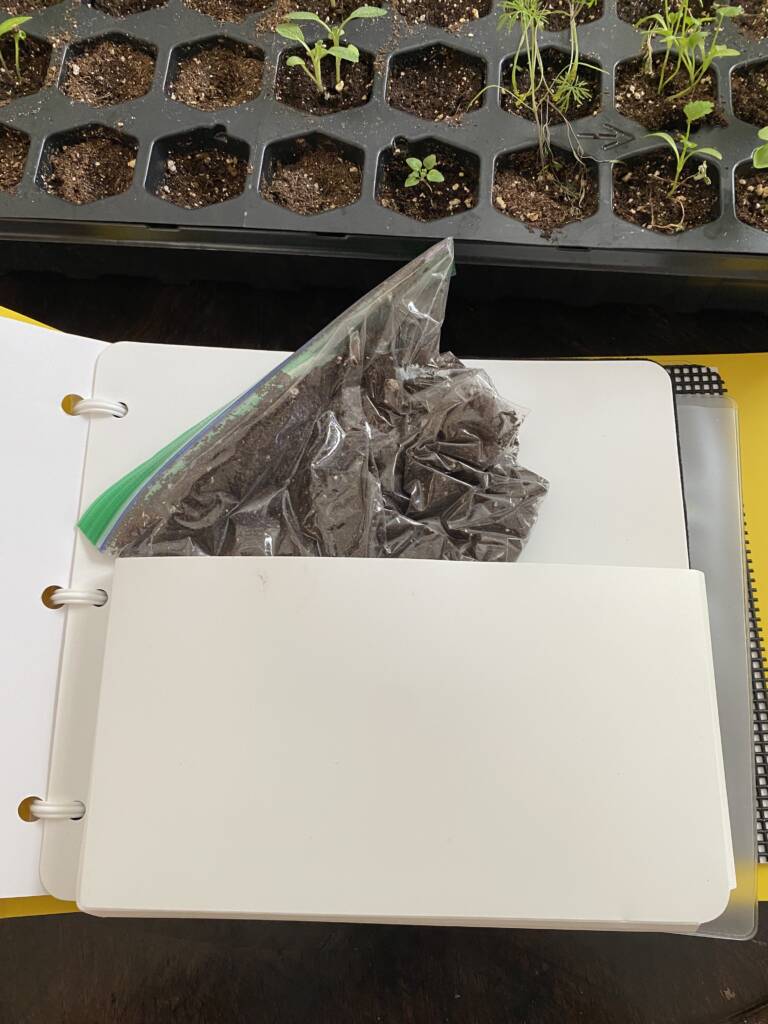 A pocket page in the Garden Book with a bag of soil.