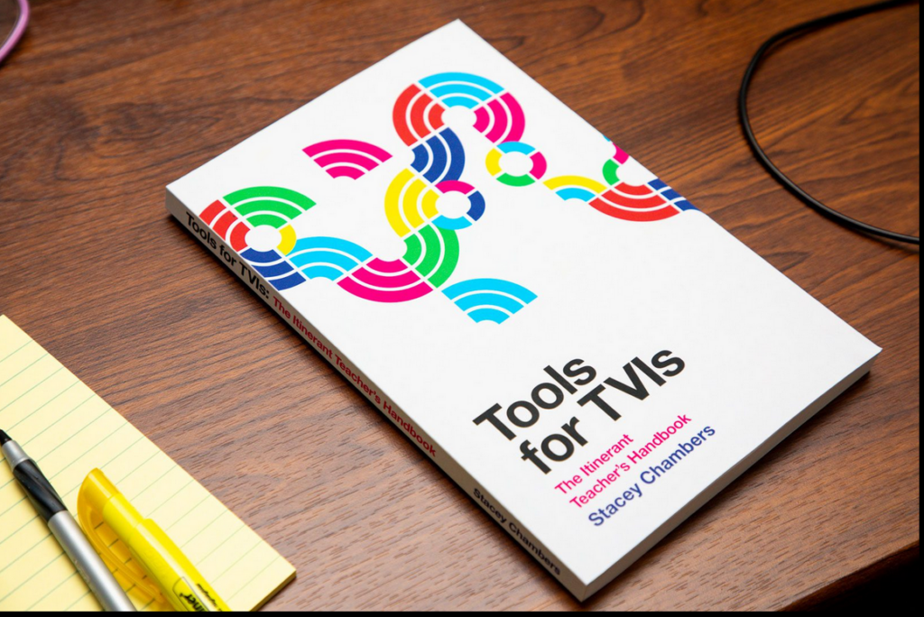 Tools for the TVI book on a table.