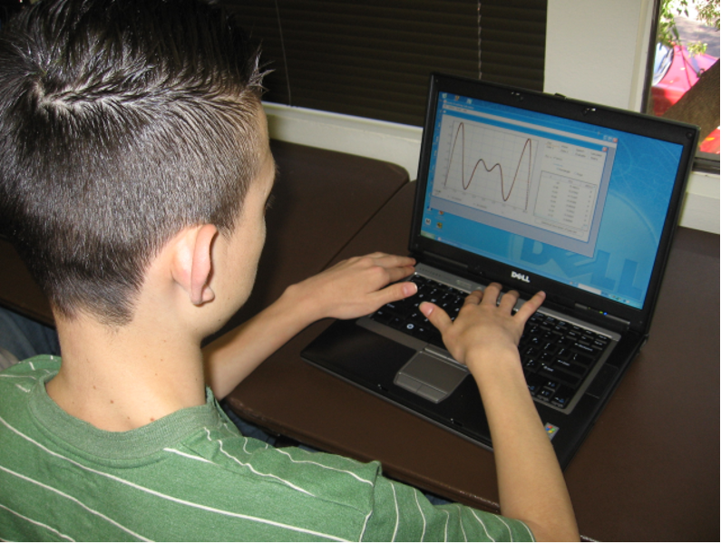 A boy using the Audio Graphing Calculator (AGC)