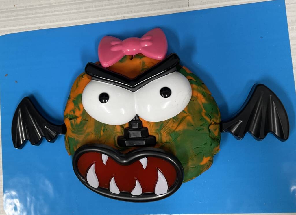 Clay flat circle made into a silly monster