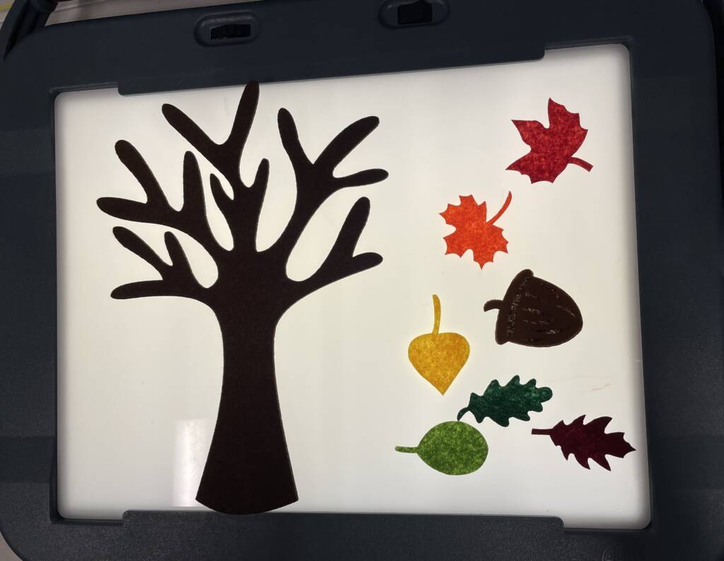 Felt tree with pieces on a lightbox.