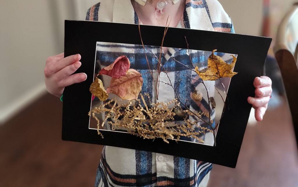 Young student holding his completed project