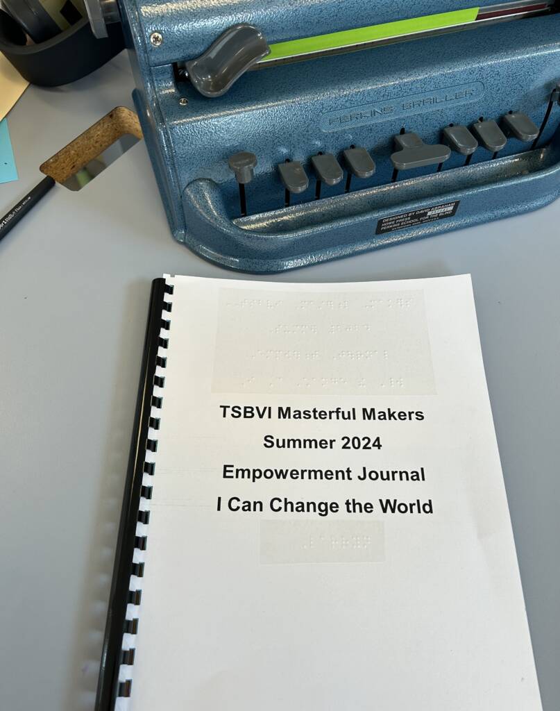 I can change the world booklet with a braille machine next to it