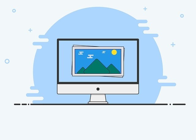 Computer screen with an illustration of mountains against a blue sky and sun.